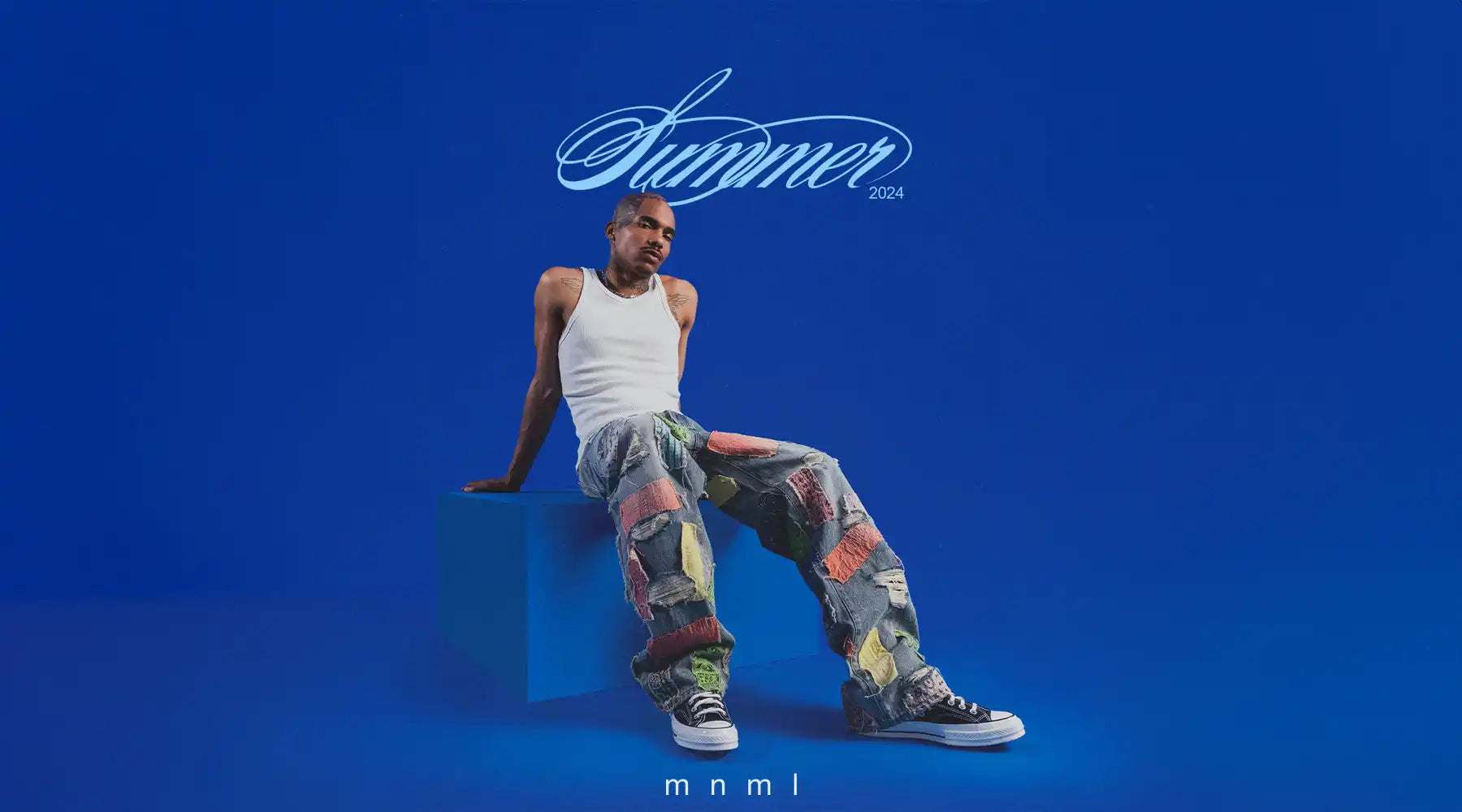 Man in tank top and patchwork pants.
