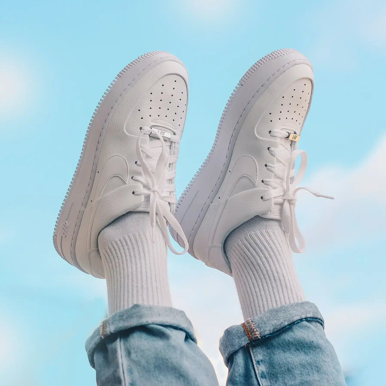 White Nike Air Force 1 sneakers.